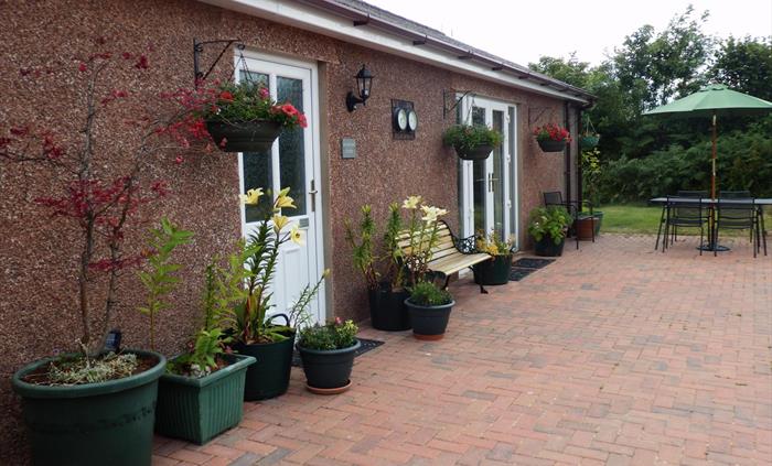 detached bungalow with private jacuzzi area to the side of the property